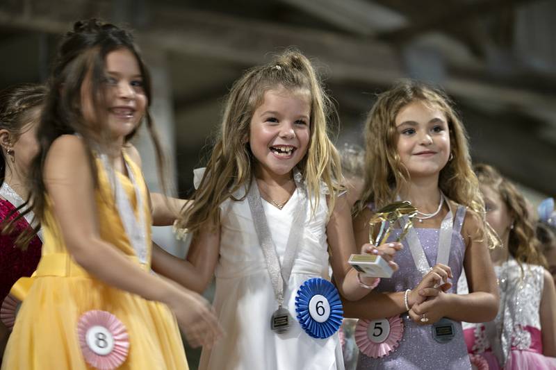 Sophie Bounds, 8, reacts to winning the best smile award in the Little Miss Ogle County pageant, Thursday, July 30, 2025, at the Ogle County Fairgrounds.