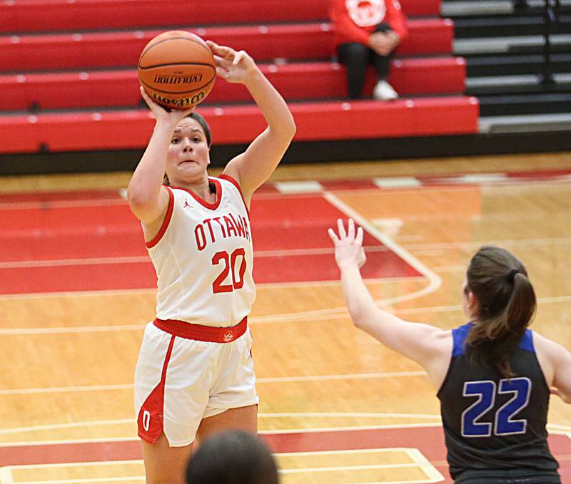 Ottawa's Kendall Lowery (left) sinks a three point basket over Princeton's Camryn Driscoll (right) on Thursday, Dec. 15, 2022 at Kingman Gymnasium in Ottawa.