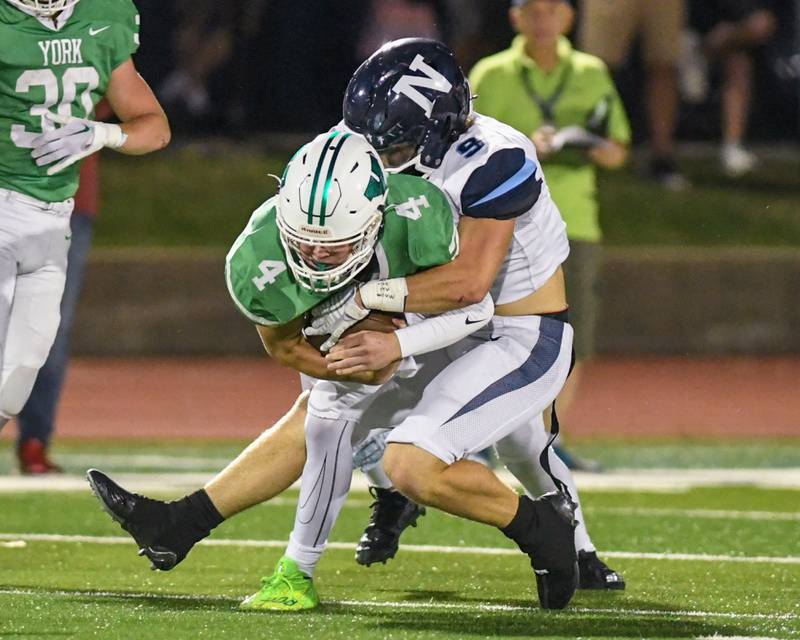 Nazareth Academy Brendan Flanagan (9) tackles York’s QB Sean Winton during the first quarter Friday Sep. 1, 2023, in Elmhurst.