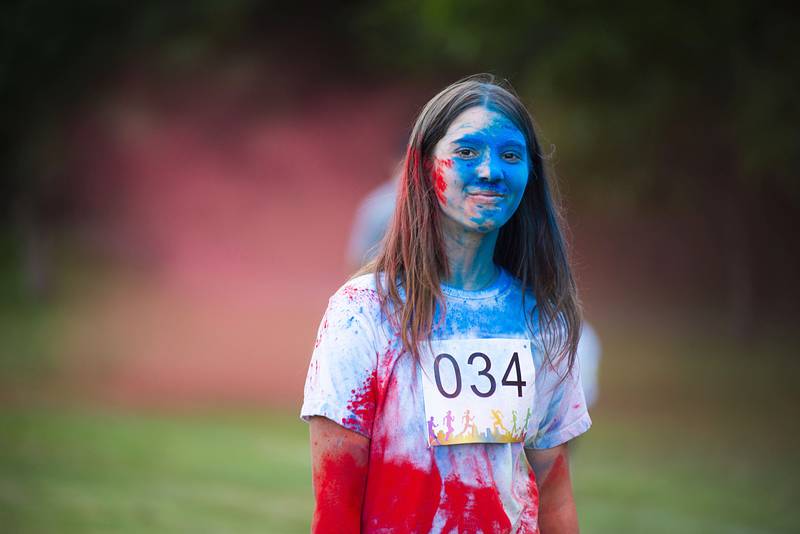 After having worked through all the color stations, Bella Henson of Prophetstown makes her way to the finish line during the Woodlawn ROY G BIV color run.
