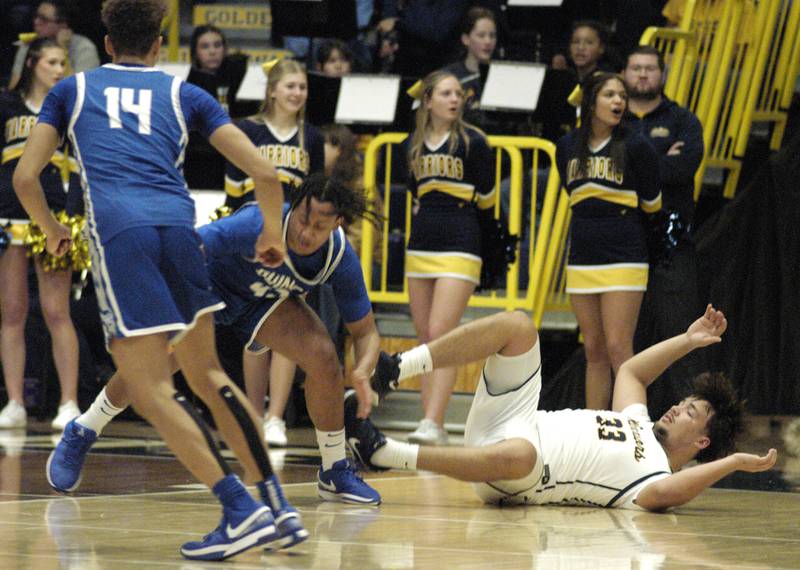 Sterling's  Maddux Osborn hits the court trying for a loose ball. The action took place on Friday, December 13th at Sterling.