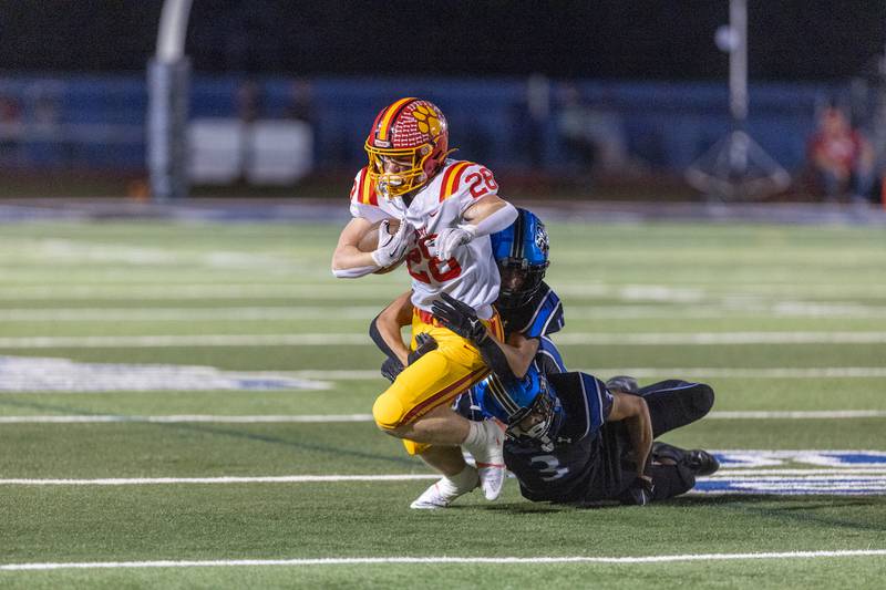 Batavia's Henry Hahn is tackled by St. Charles North's defense on Friday, Sept. 26, 2025 in St. Charles.