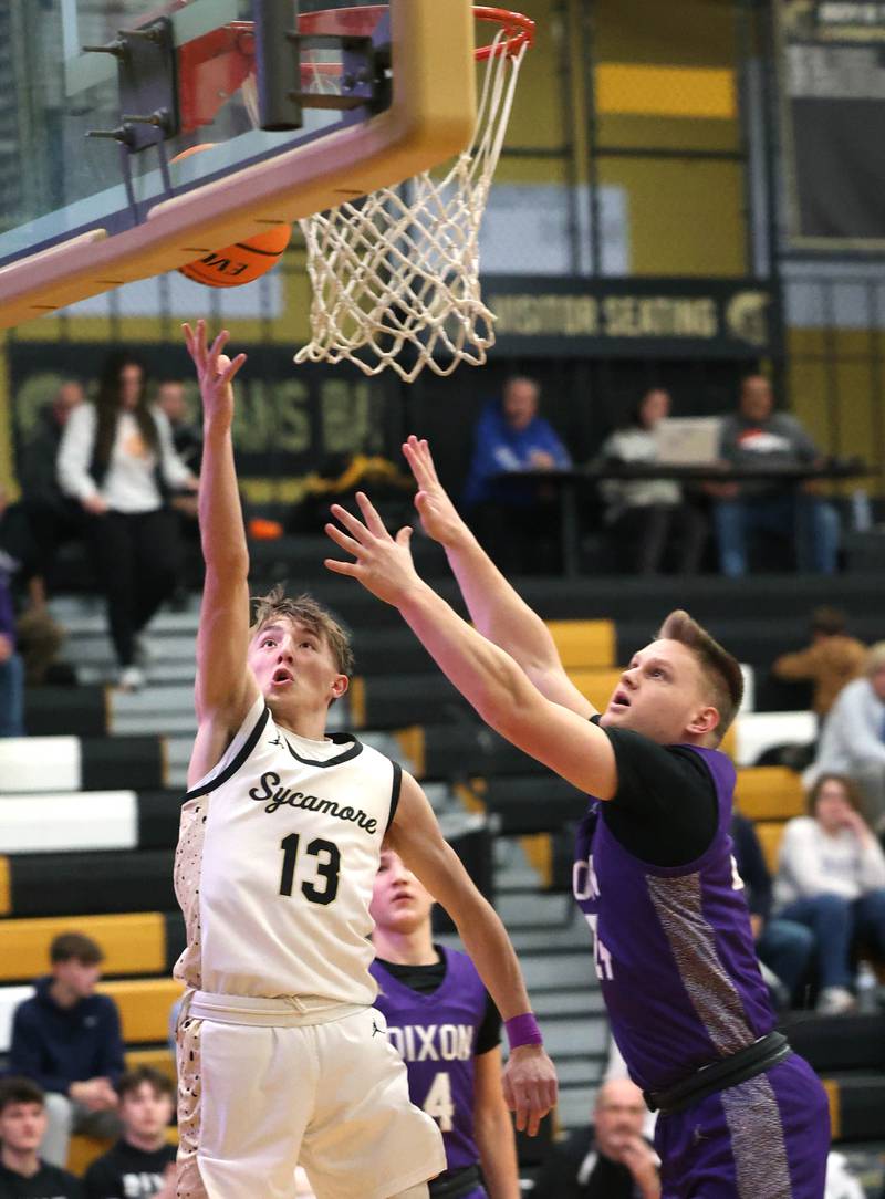 Sycamore's Xander Lewis shoots a layup ahead of Dixon’s Eli Davidson during their game Tuesday, Jan. 14, 2025, at Sycamore High School.