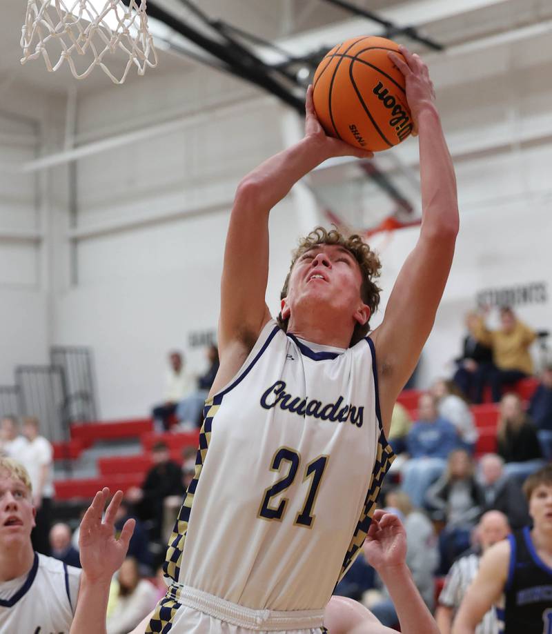 Marquette's Lucas Craig shoots in front of Hinckley-Big Rock's Marshall Ledbetter Tuesday, March 3, 2026, during their sectional semifinal matchup at Amboy High School.