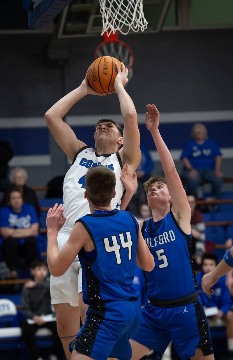 Central's Conner Unger elevates for a shot as Milford's Jack VanHoveln, center, and Isaac Schaumburg, right, guard during a Class A Regional game on Monday, Feb. 23, 2026.
