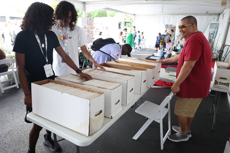 People browse comics of one of the many vendors at Comicolopis, Lockport’s 7th annual Comic and Fandom Con on Saturday, July 29.