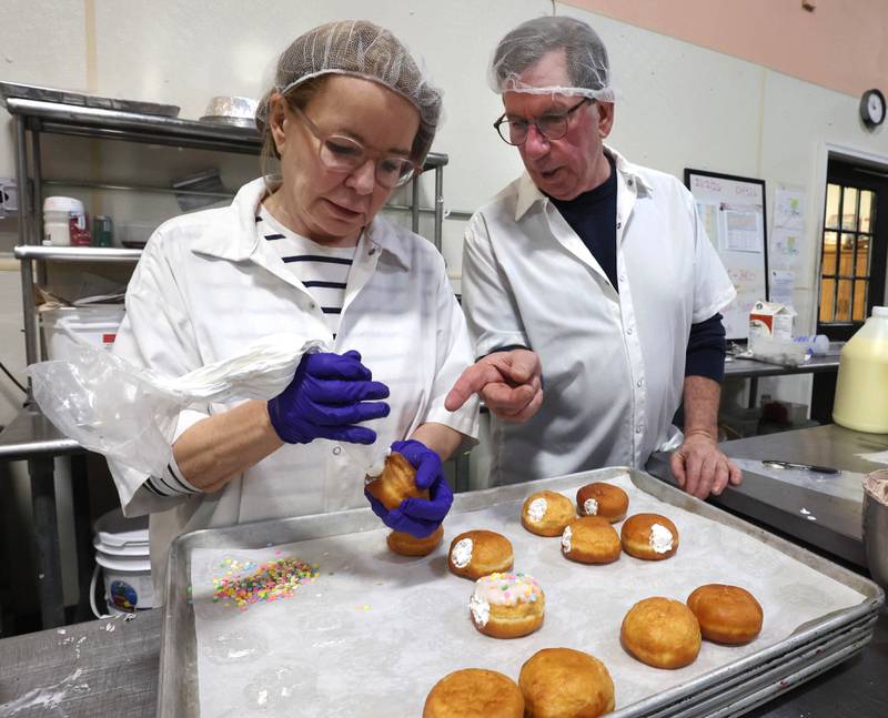 Lala’s Bagels co-owners Donna McMahon (left) and her husband Gerry make paczkis Thursday, Feb. 12, 2026, at the store, as they prepare for Paczki Day, Tuesday, Feb. 17, their busiest day of the year.