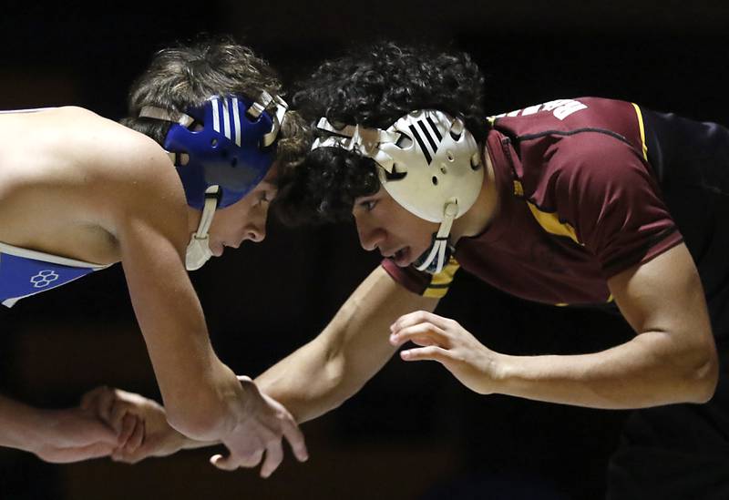 Richmond-Burton’s Aiden Almanza (right)  battles with Johnsburg’s Micah Klos in the 132-pound match of a Kishwaukee River Conference wrestling meet on Thursday, Jan. 30, 2025, at Johnsburg High School.