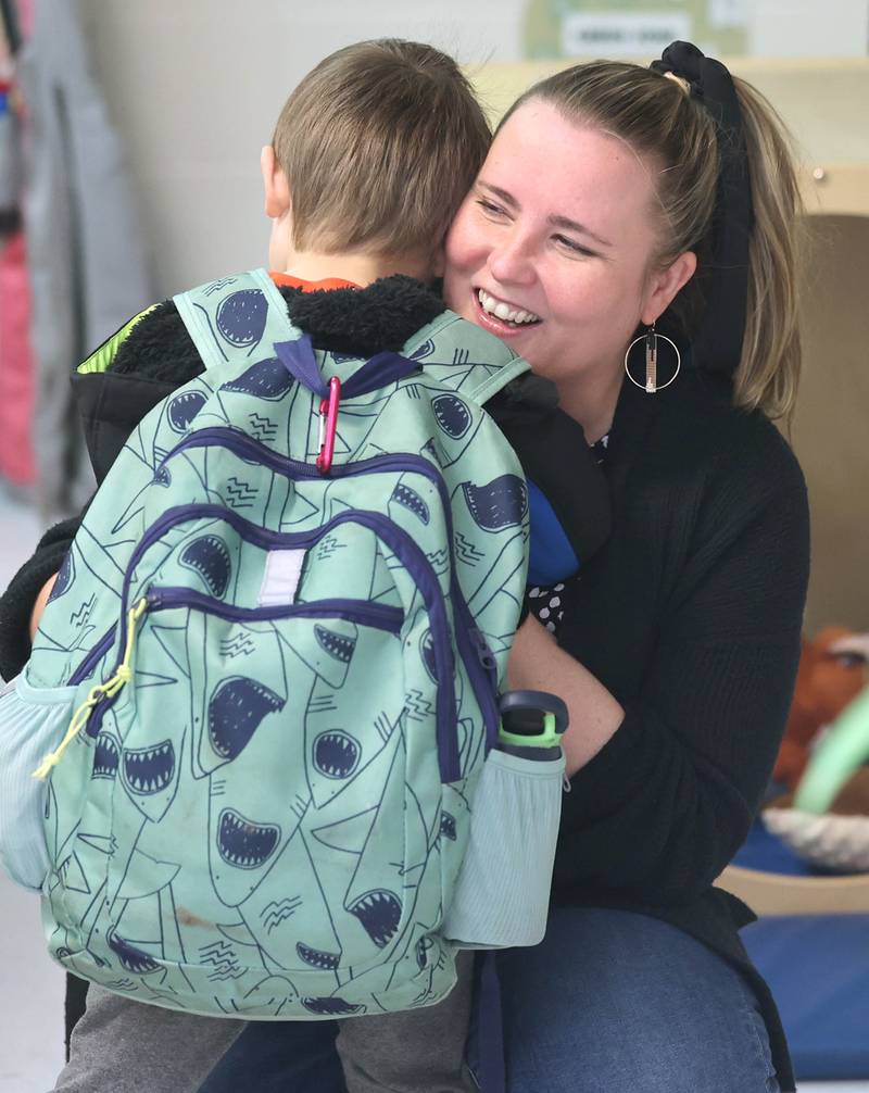 Laurel Copeland, Little Spartans Early Learning Program teacher at South Prairie Elementary School, greets Henry Landis as he arrives Wednesday, April 6, 2023, at the school in Sycamore.