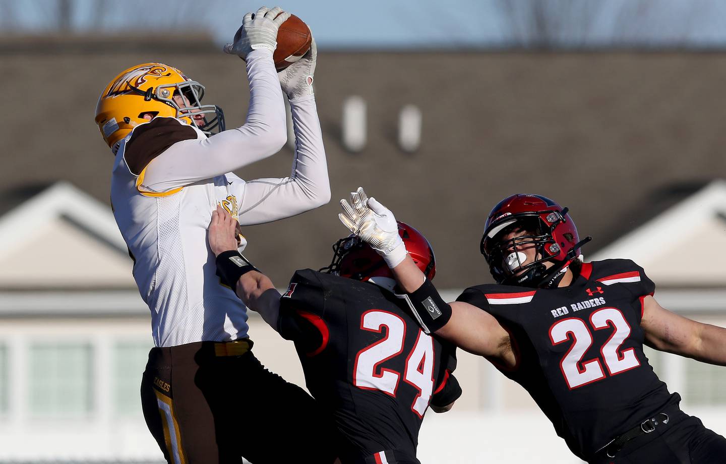 Jacobs's Grant Stec, left, hauls in a long pass for a touchdown ahead of Huntley's Nicholas Martino, center, and Christopher Medina, right, during their season opening football game at Huntley High School on Friday, March 19, 2021 in Huntley.