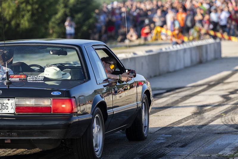 A passenger hangs out the side of a ride to get a video of a burnout Thursday, June 19, 2025, in Rock Falls.