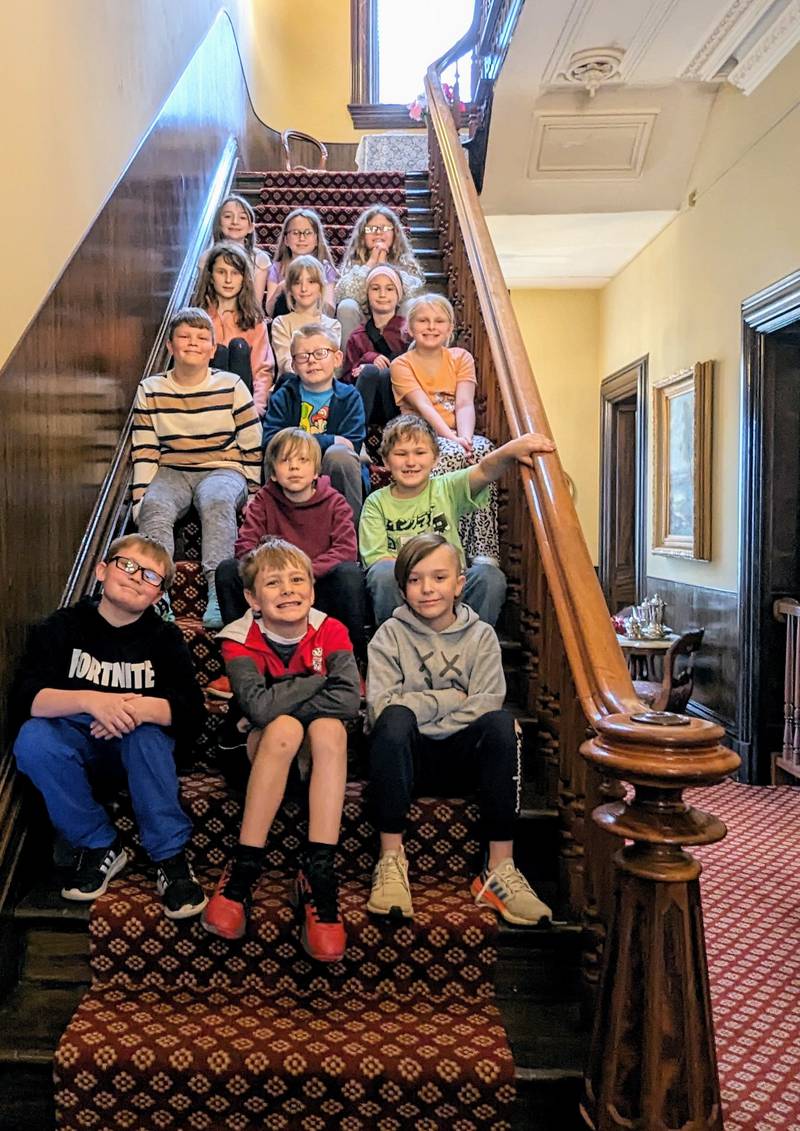 Grand Ridge third graders pause for a photo on the main stairway of the Reddick Mansion