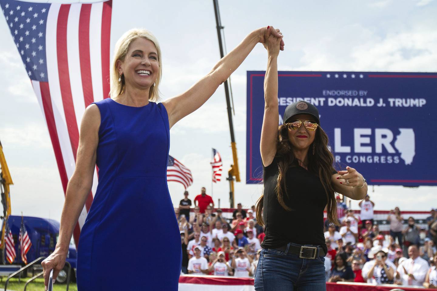 U.S. Rep. Mary Miller, of Illinois, left, is joined by U.S. Rep. Lauren Boebert, of Colorado, on stage at a rally at the Adams County Fairgrounds in Mendon, Ill., Saturday, June 25, 2022. (Mike Sorensen/Quincy Herald-Whig via AP)