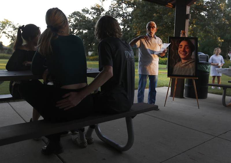 Peter Passuntino talks about his grandson, Riely Teuerle, during a candlelight celebration for Teuerle on Thursday, August 11, 2022, at Towne Park, 100 Jefferson Street in Algonquin. Teuerle was killed in a car crash in Lake in the Hills on Tuesday. Over 100 family members and friends gathered at the park to remember and celebrate Teuerle’s life.