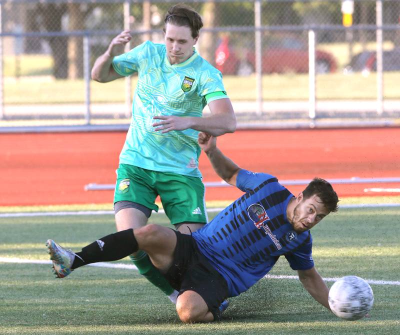 DeKalb County United's Johnny Kraemer (left) tries to retain possession as Rockford FC's Colby Newquist slides in Wednesday, July 13, 2022, as the teams battle for the 815 Cup at the Northern Illinois University Soccer and Track and Field complex in DeKalb.