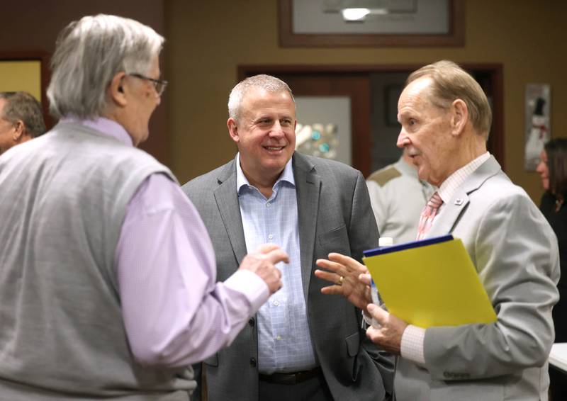 Current DeKalb Mayor Cohen Barnes, who is running for re-election, former DeKalb Mayor Jerry Smith (left) and Second Ward Alderman candidate Michael Embrey (right) talk Wednesday, Feb. 19, 2025, during the DeKalb Area Rental Association and DeKalb Area Builders Association Candidate Night at Faranda's Banquet Center in DeKalb.