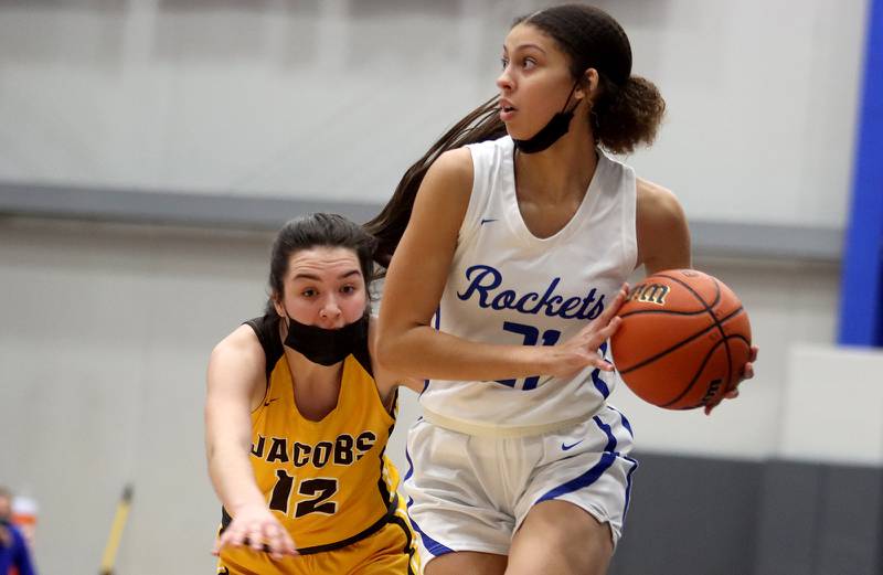 Burlington Central’s Taylor Charles, right, eludes Jacobs’ Bridget Grady during girls varsity basketball at Burlington Tuesday night.