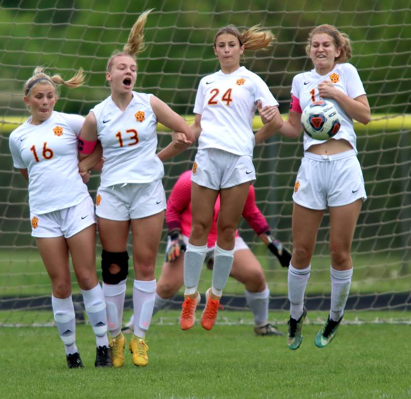 From left, Richmond-Burton’s Lexie Anderson, Jordan Otto, Ember Demers, and Madison Havlicek join forces to stop a  DePaul Prep kick during sectional title game action at Marian Central in Woodstock Friday evening.