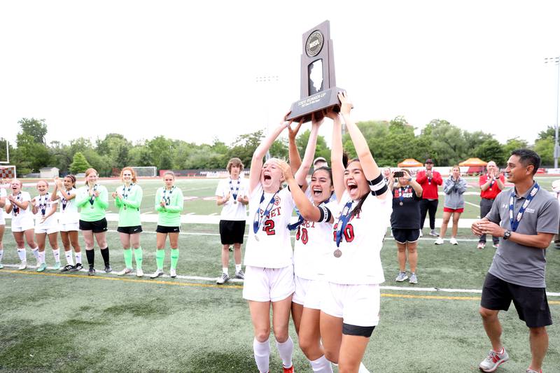 Benet team captains hoist their second-place trophy following their IHSA Class 2A state championship game loss to Triad at North Central College in Naperville on Saturday, June 4, 2022.