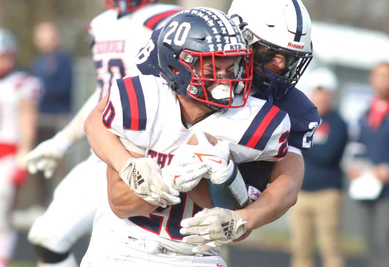 Cary-Grove’s Brady Elbert wraps up Belvidere North’s Erick Roman in IHSA Class 6A quarterfinal playoff football action on Saturday, Nov. 16, 2024, at Al Bohrer Field on the campus of Cary-Grove High School in Cary.