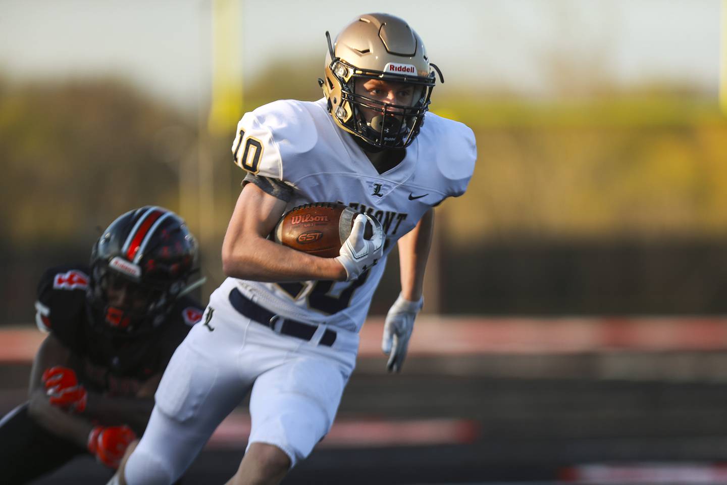 Lemont wideout Luke Wallace breaks a tackle on Friday, April 16, 2021, at Bolingbrook High School in Bolingbrook, Ill.