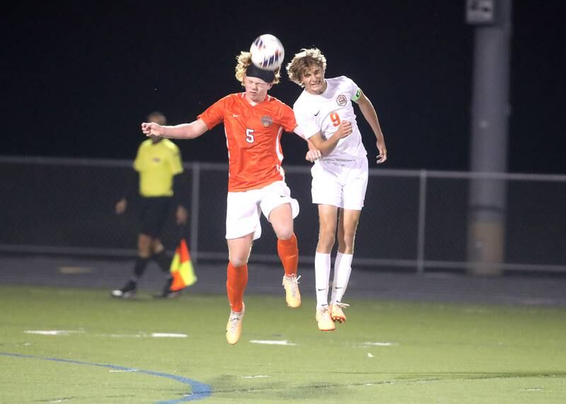 St. Charles East’s Jake Walker (left) and Crystal Lake Central’s Owen Kaiser head the ball during a game at Streamwood on Tuesday, Sept. 12, 2023.