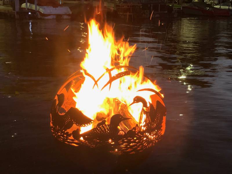 One of several fire globes is aglow in McHenry on Saturday, Sept. 27, 2025 during the annual Light the Night. The city lights fires in the 15 fire globes sitting in the water along the McHenry Riverwalk.