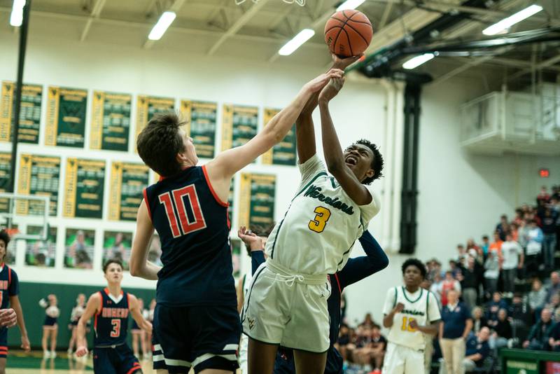 Waubonsie Valley's Tre Blissett (3) shoots the ball in the post against Oswego’s Josh Nelson (10) during a Waubonsie Valley 4A regional semifinal basketball game at Waubonsie Valley High School in St.Charles on Wednesday, Feb 22, 2023.