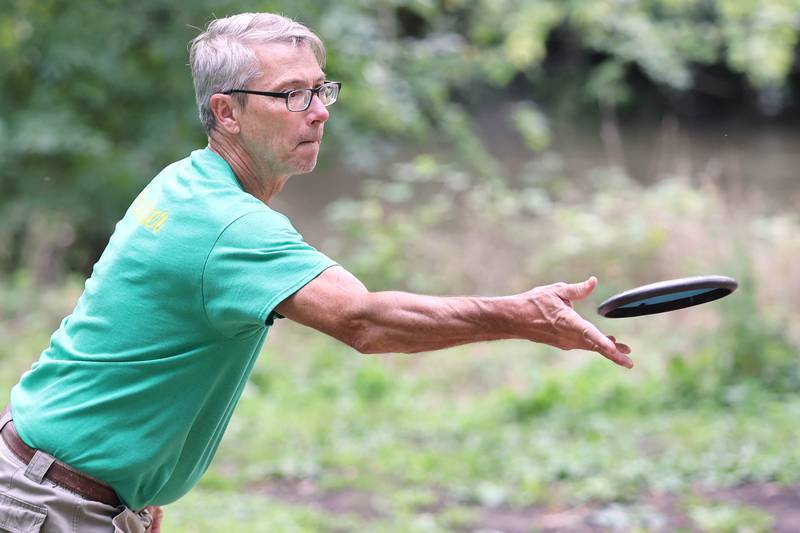 Brian Wallace, with the Kishwaukee Valley Wanderers, takes a shot Thursday, Sept. 2, 2022, at the new River Run Disc Golf Course in David Carroll Memorial Park in Genoa.