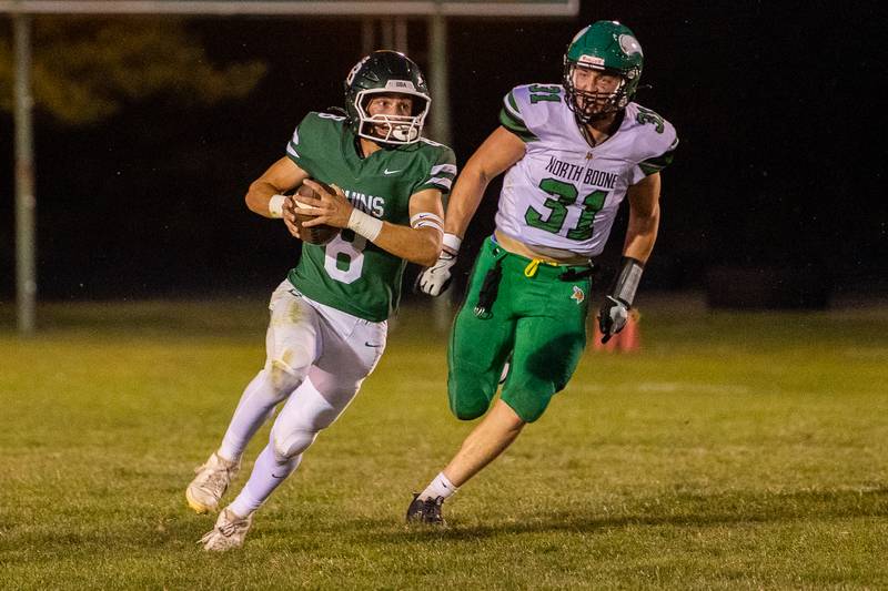 Gino Ferrari (8) of St. Bede runs ball as Brad Dahl (31) of North Boone trails on Friday, Sept 12, 2025 at Captain Thomas J. Heitmann field in Peru.