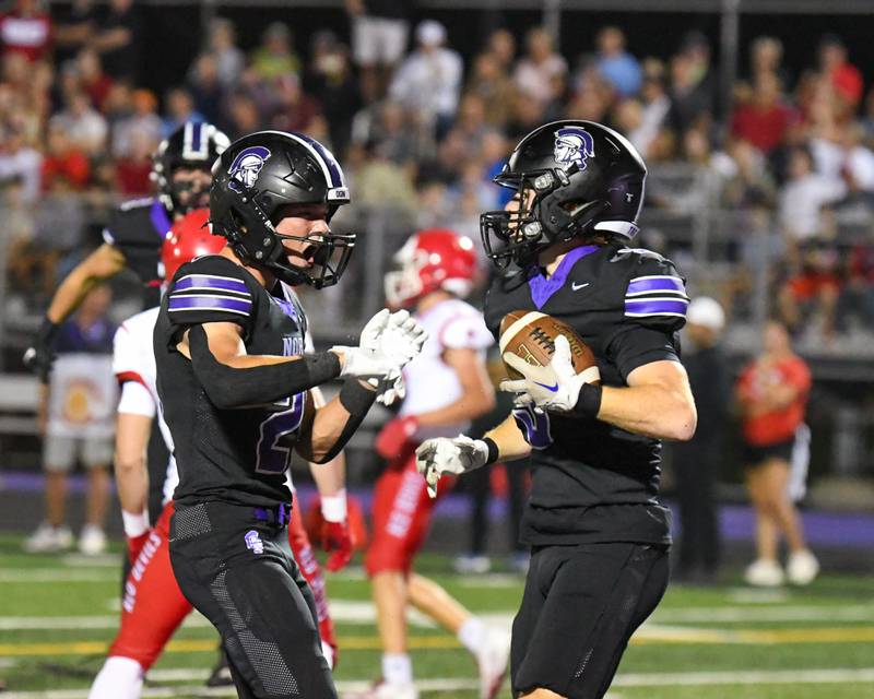 Downers Grove North's Connor Crowley, left, celebrates with teammate Max Troha after Max intercepts the ball from a Hinsdale Central defender during the game on Friday Sept. 12, 2025, held at Downers Grove North High School.