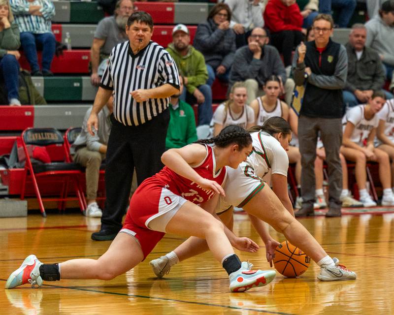 Kendal Bassett (12) of LaSalle-Peru reaches for ball after losing dribble whilst Mary Stisser (23) of Ottawa looks to steal on Wednesday, December 17, 2025 at Sellet Gymnasium in LaSalle.