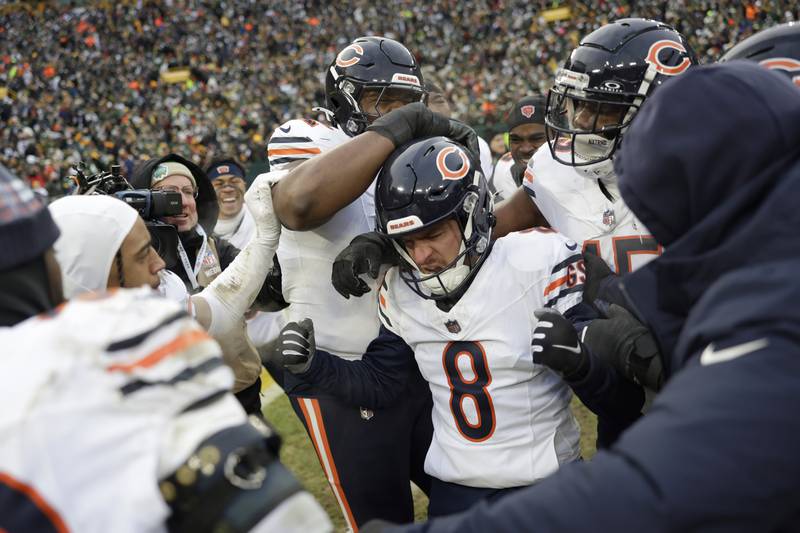 Chicago Bears place kicker Cairo Santos (8) is congratulated by teammates after kicking the game winning field goal during the second half of an NFL football game against the Green Bay Packers, Sunday, Jan. 5, 2025, in Green Bay, Wis. (AP Photo/Matt Ludtke)
