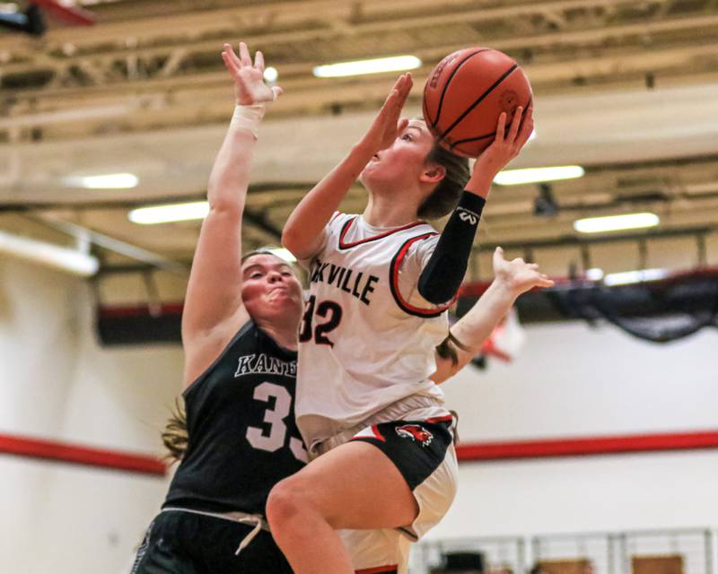 Yorkville's Lainey Gussman (32) goes up for a layup defended by Kaneland's Natalie Myers (33) during varsity basketball game between Kaneland at Yorkville. Dec 14, 2022.