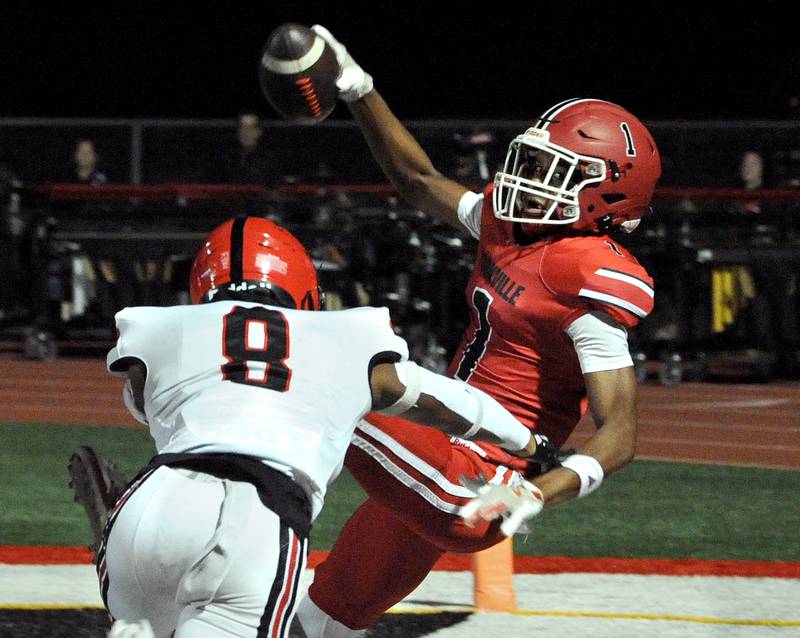 Yorkville receiver Dyllan Malone (1) gets hit hard by Bolingbrook defender Darieon Prescott (8), but not before scoring on a jet sweep on Friday, Sept. 27, 2024, during a varsity game at Yorkville High School.