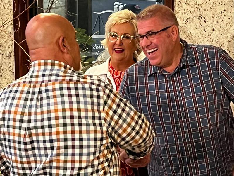 Gubernatorial candidate Darren Bailey, with his wife, Cindy, greets a supporter Saturday at a meet-and-greet at the new GOP headquarters in Rock Falls.