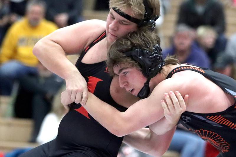 Huntley’s Jake Niemasz (left) battles McHenry’s Peyton Horowicz at 182 pounds in their Fox Valley Conference dual on Friday in Huntley.