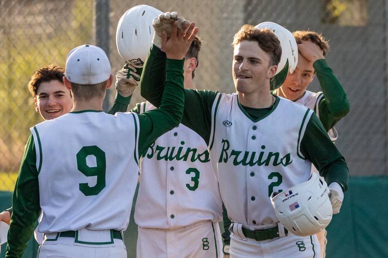 (Right) Gus Burr (2) of St. Bede celebrates home run with teammate (left) Geno Dinges (9) on Tuesday, April 15, 2025 at St. Bede Academy in Peru.