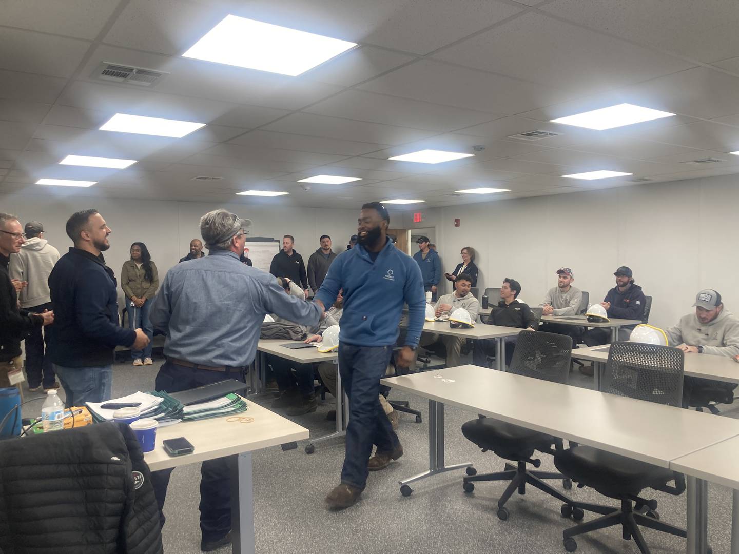 Instructor Matt Nugent congratulates apprentice Theo Reynolds at the Joliet Training Center Graduation March 15.