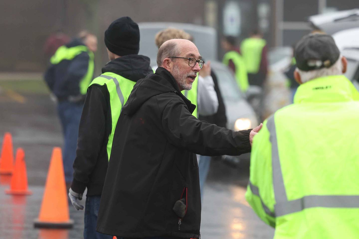 Lockport Township High School Superintendent Dr. Bob McBride talks with a volunteer supervisor during ShareFest at Lockport Township High School East campus on Sunday, Dec. 15, 2024.