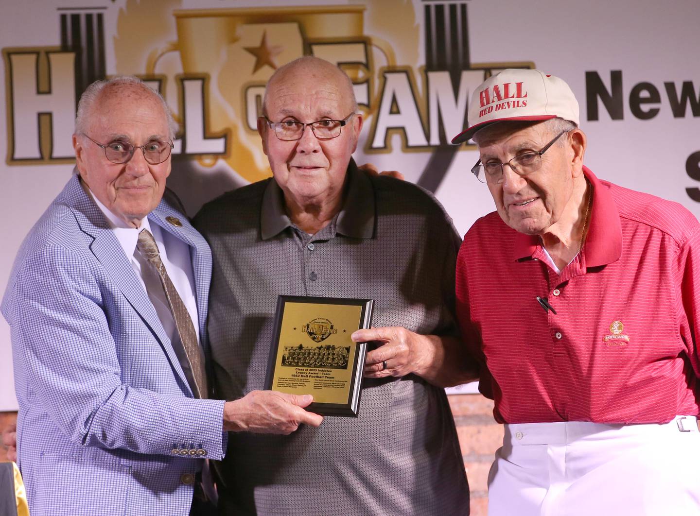 Lanny Slevin, Emcee presents the legacy award to Roger Bruno and Ron Malooley who were members of the 1953 Hall High School football team who went 9-0 during the Shaw Media Illinois Valley Sports Hall of Fame on Thursday, June 8, 2023 at the Auditorium Ballroom in La Salle.