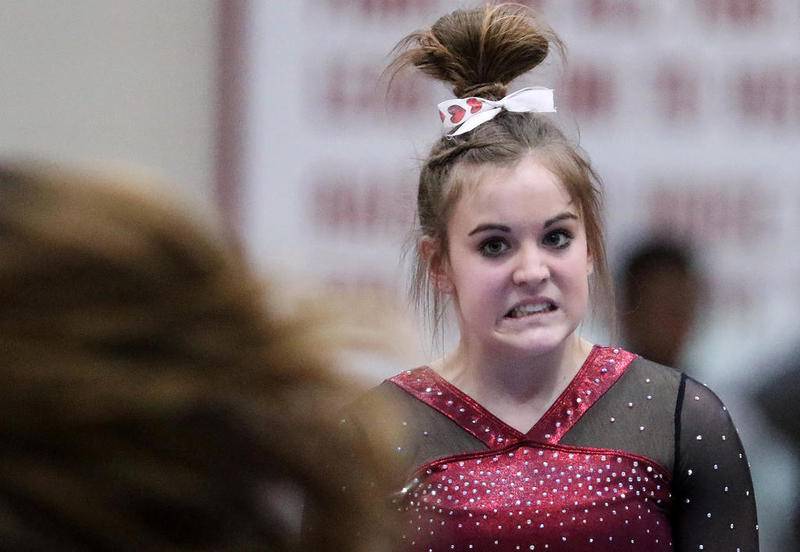 Prairie Ridge co-op's Gracie Willis reacts after her dismount on the balance beam during the Schaumburg Sectional on Feb. 12 in Schaumburg.