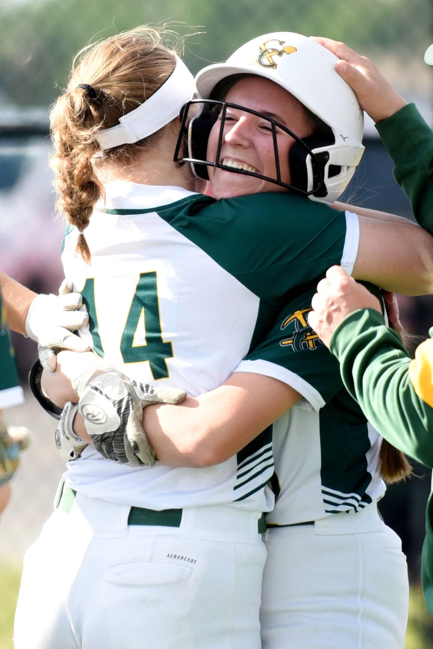 Coal City's Madi Petersen, right, is hugged by Brittnae Combs after hitting a three-run home run during the Class 2A Coal City Regional championship against Bishop McNamara Friday, May 23, 2025.