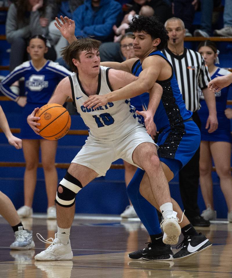 Clifton Central's Blake Chandler, left, controls the ball as Milford's Mario Martinez tightly guards during a Class A Regional game on Monday, Feb. 23, 2026.