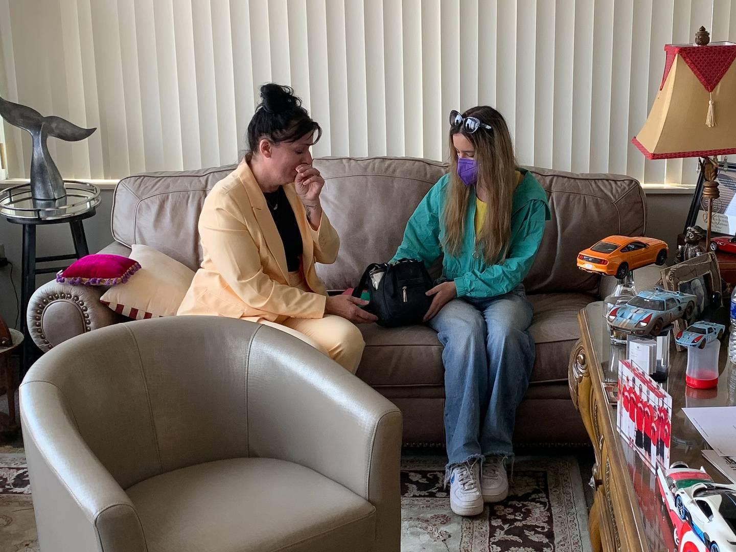 An emotional Suzanna Ibarra, left, and her daughter Rosalinda Ibarra hold a purse returned to them by Will County State’s Attorney James Glasgow.