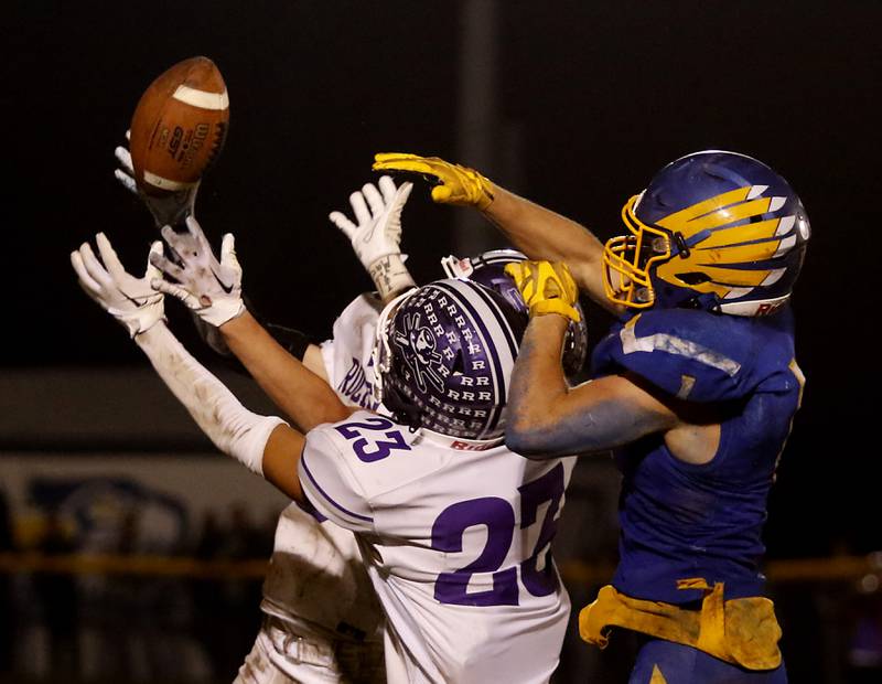 Johnsburg's Jake Metze, right, tries to keep Rochelle's Tommy Tourdot, left, and Aidan Rodriguez, center from intercepting a pass in the fourth quarter of a IHSA Class 4A second round playoff football game Friday, Nov. 4, 2022, between Johnsburg and Rochelle at Johnsburg High School in Johnsburg.