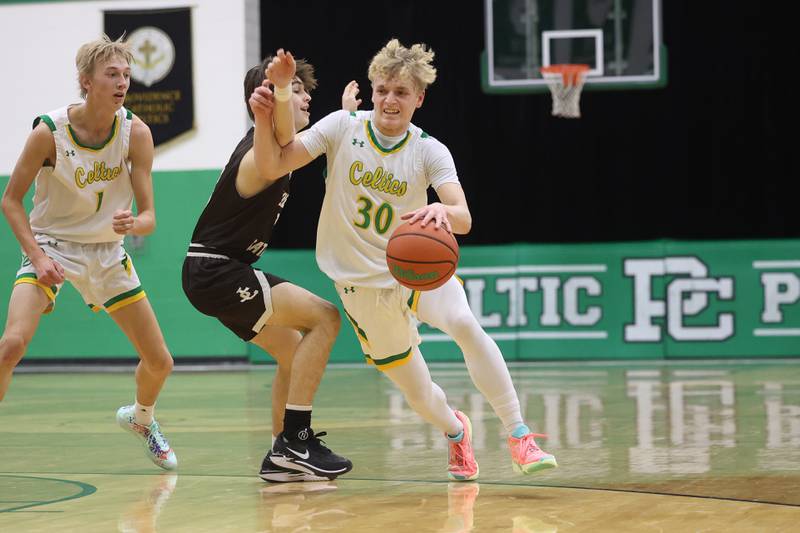 Providence’s Seth Cheney makes a move against Joliet Catholic on Saturday, Dec. 9th, 2023 in New Lenox.