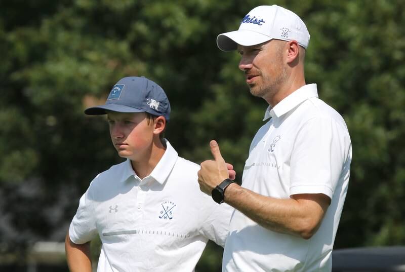 Geneva golf coach Eric Hatczel talks to Matt Trimble on the first tee during the Mark Rolfing Cup Monday, Aug. 21, 2023, at the Kishwaukee Country Club in DeKalb.