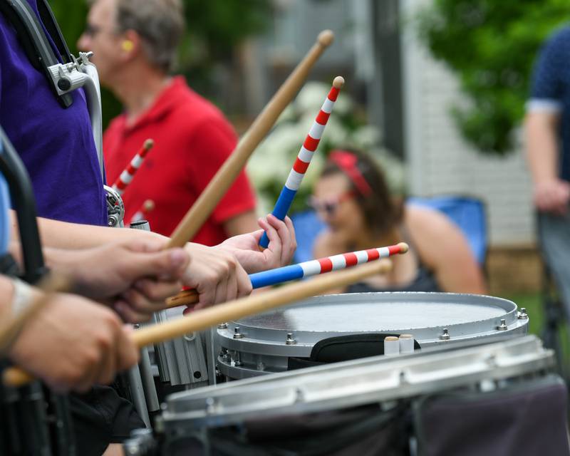 Downers Grove North and Downers Grove South marching band drummers use patriotic drumsticks during the Independence Day parade on Friday July 4, 2025, held in downtown Downers Grove.