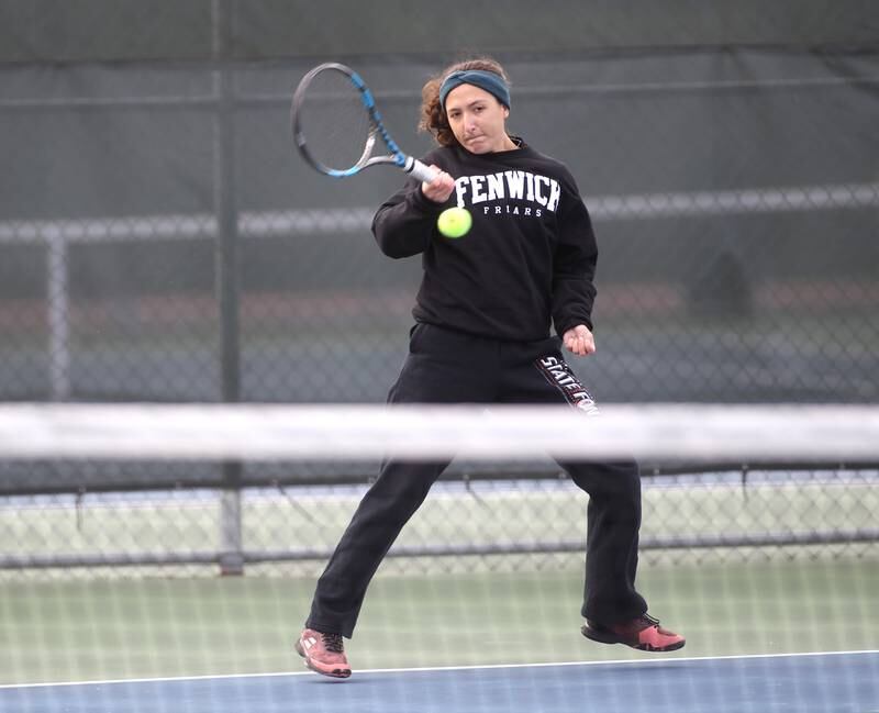 Fenwick’s Megan Trifilio returns the ball during the first day of the IHSA state tennis tournament at Rolling Meadows High School on Thursday, Oct. 20, 2022.